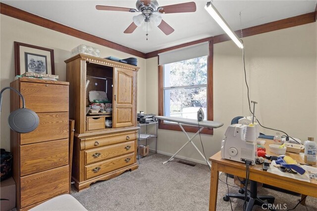 home office with light colored carpet, ceiling fan, and baseboards