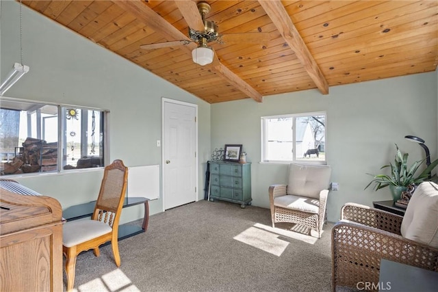 interior space with lofted ceiling with beams, wooden ceiling, carpet flooring, and a ceiling fan