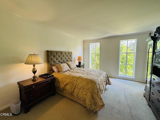 carpeted bedroom with baseboards and crown molding