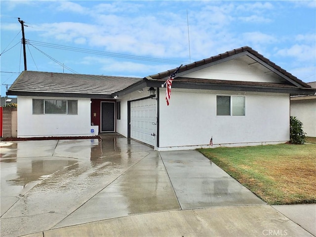 ranch-style home with a garage and a front yard