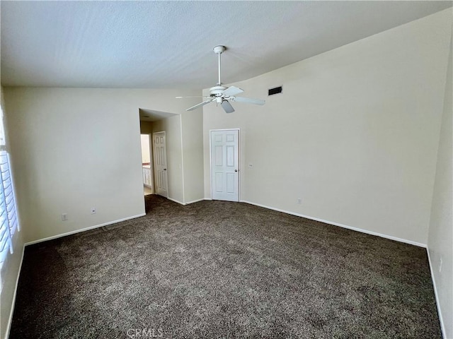 carpeted spare room featuring lofted ceiling, a textured ceiling, and ceiling fan