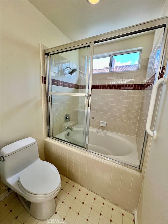 bathroom with shower / bath combination with glass door and toilet