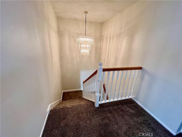 stairs with carpet and a chandelier