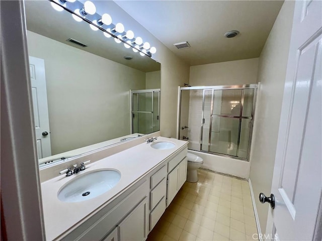 full bathroom featuring enclosed tub / shower combo, vanity, and toilet