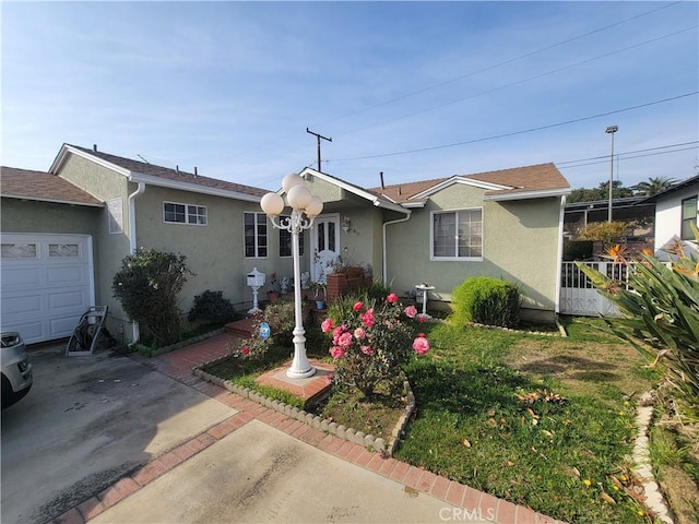 ranch-style home with a garage and a front lawn