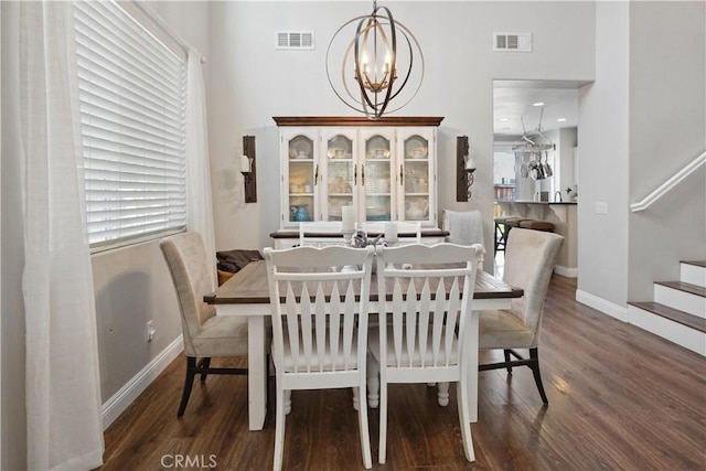31242 Bell Mountain Rd, Menifee, CA 92584 - dining room featuring a chandelier, wood finished floors, stairs, and baseboards