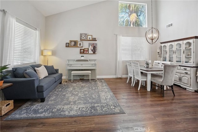 31242 Bell Mountain Rd, Menifee, CA 92584 - living room with a chandelier, dark wood-style flooring, high vaulted ceiling, and baseboards