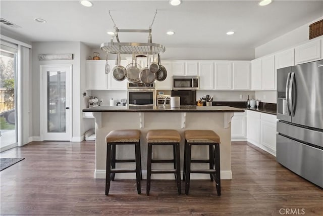 31242 Bell Mountain Rd, Menifee, CA 92584 - kitchen with appliances with stainless steel finishes, dark countertops, white cabinetry, and recessed lighting