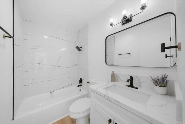 full bathroom featuring tiled shower / bath combo, vanity, and toilet