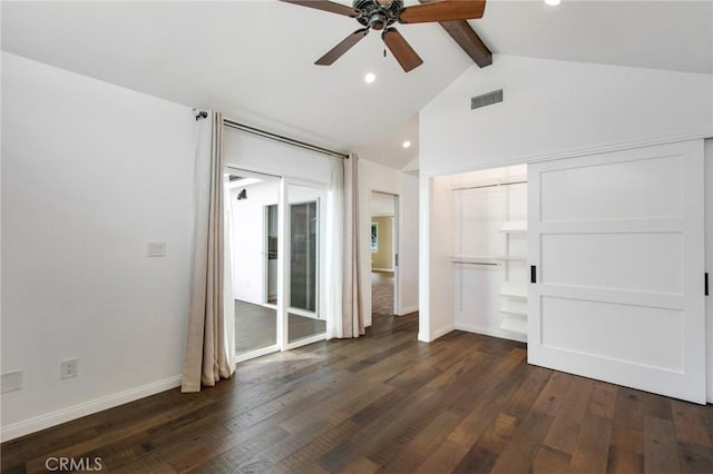 unfurnished bedroom featuring ceiling fan, dark hardwood / wood-style flooring, and vaulted ceiling with beams