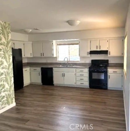 kitchen featuring white cabinetry, sink, dark wood-type flooring, and black appliances