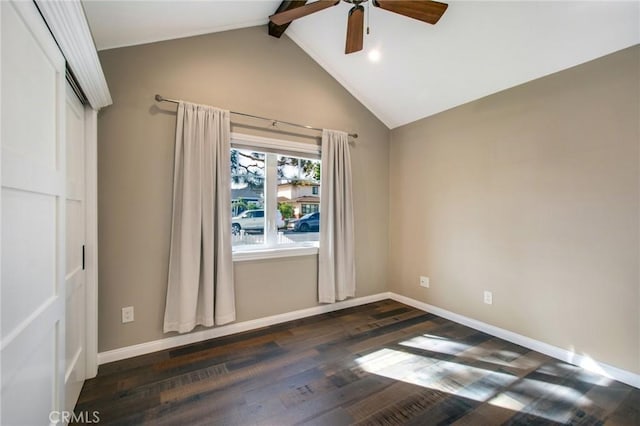 empty room featuring dark wood-type flooring, ceiling fan, and vaulted ceiling with beams