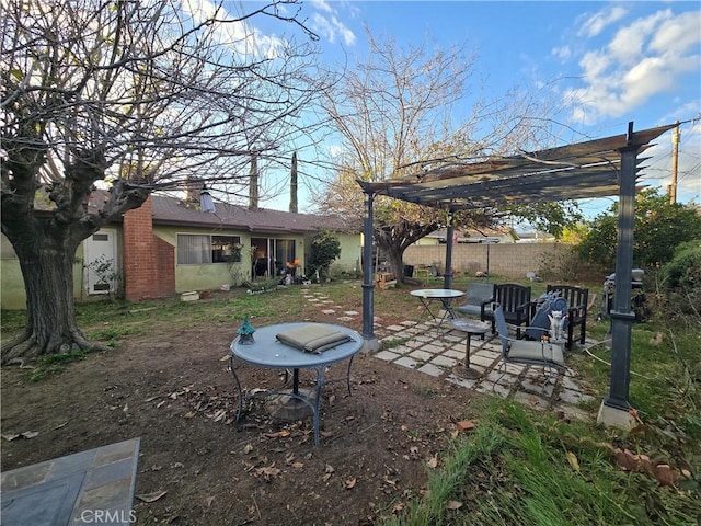 view of yard featuring fence, a patio, and a pergola