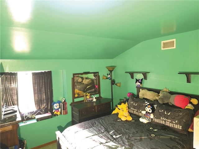 bedroom with lofted ceiling and visible vents