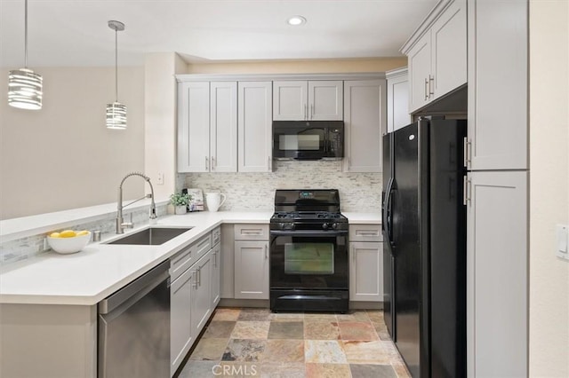 kitchen with gray cabinetry, sink, hanging light fixtures, and black appliances