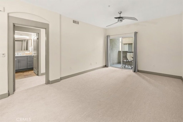 interior space featuring light colored carpet and ceiling fan