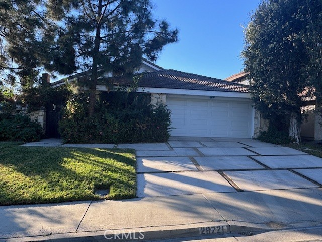 view of front of home with a garage and a front lawn