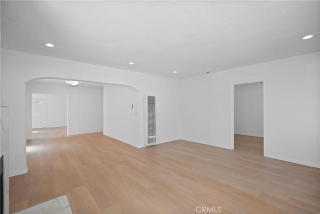 unfurnished room with ornamental molding and light hardwood / wood-style floors