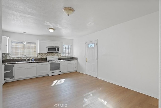 kitchen featuring white cabinetry, white appliances, pendant lighting, and tasteful backsplash