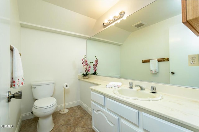 bathroom with vanity, tile patterned floors, and toilet