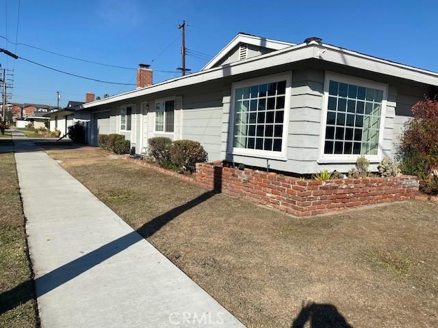 view of property exterior featuring a lawn