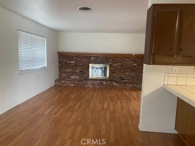 unfurnished living room with hardwood / wood-style flooring