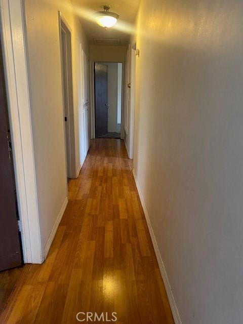 corridor with light hardwood / wood-style flooring