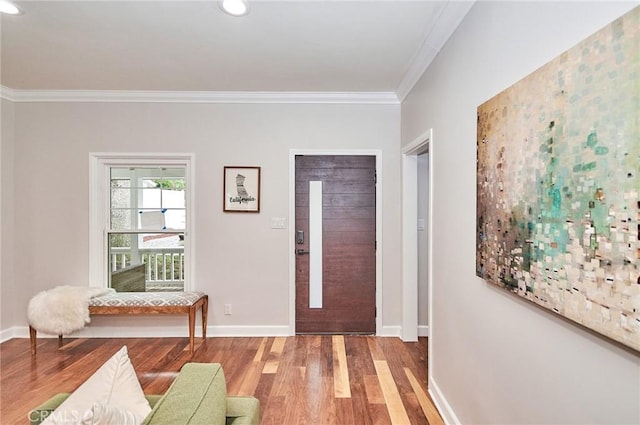 foyer entrance featuring hardwood / wood-style floors and ornamental molding