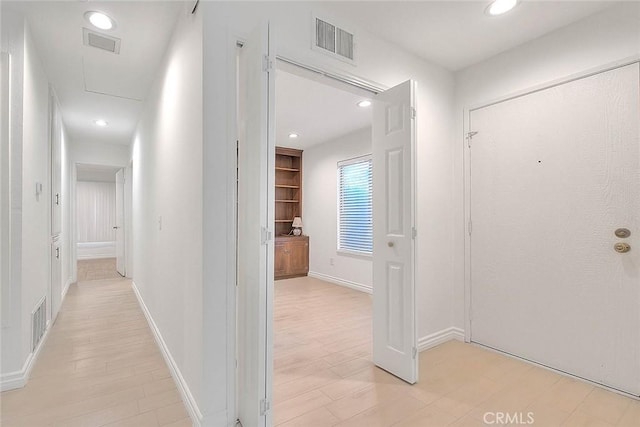 hallway featuring recessed lighting, visible vents, and light wood finished floors