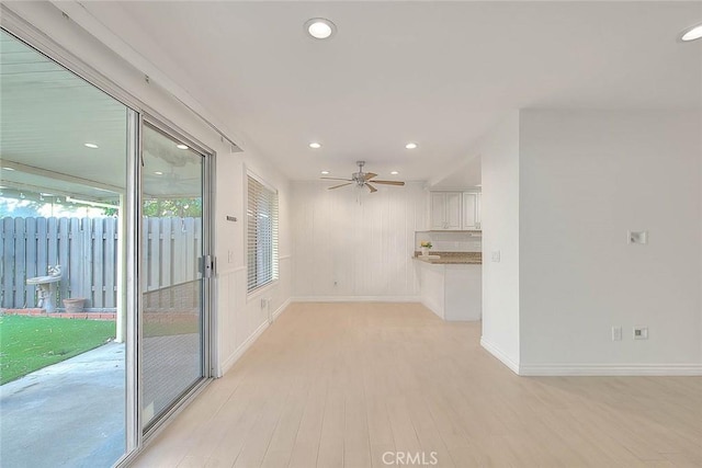 unfurnished living room featuring recessed lighting, baseboards, ceiling fan, and light wood finished floors