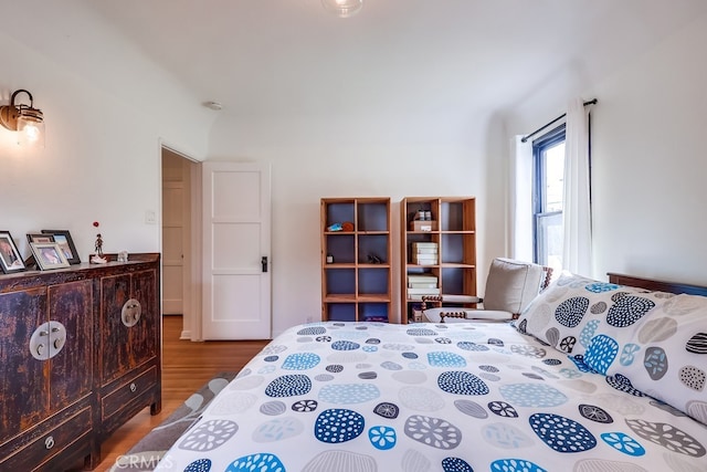 bedroom with hardwood / wood-style flooring