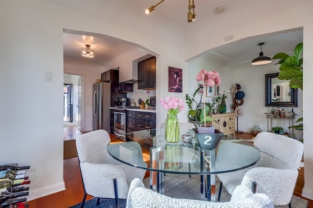 dining area with dark wood-type flooring