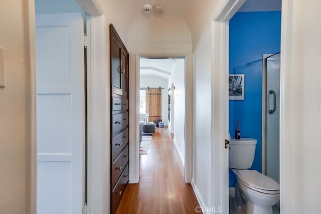 hallway featuring hardwood / wood-style flooring and a barn door