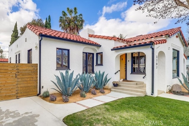 mediterranean / spanish-style house featuring a front yard