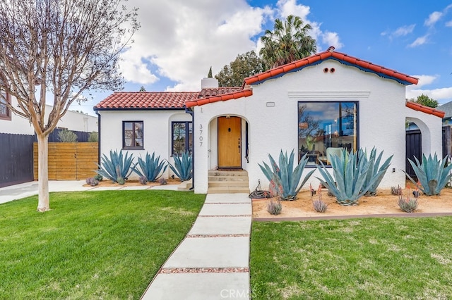 mediterranean / spanish home featuring a front yard