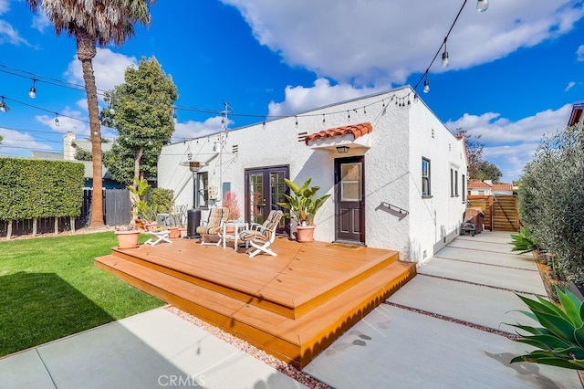 rear view of house featuring a yard and a deck