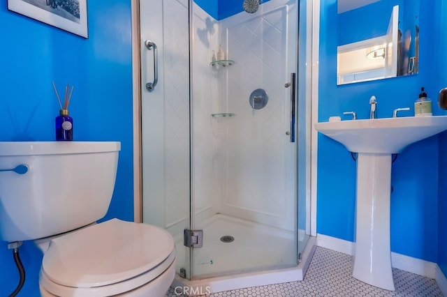 bathroom featuring walk in shower, toilet, and tile patterned flooring