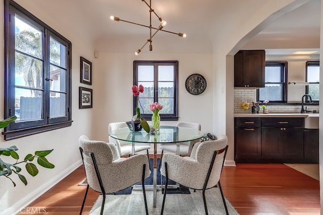 dining space with dark hardwood / wood-style flooring and sink