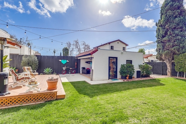 rear view of house featuring a yard, a patio area, and an outdoor structure