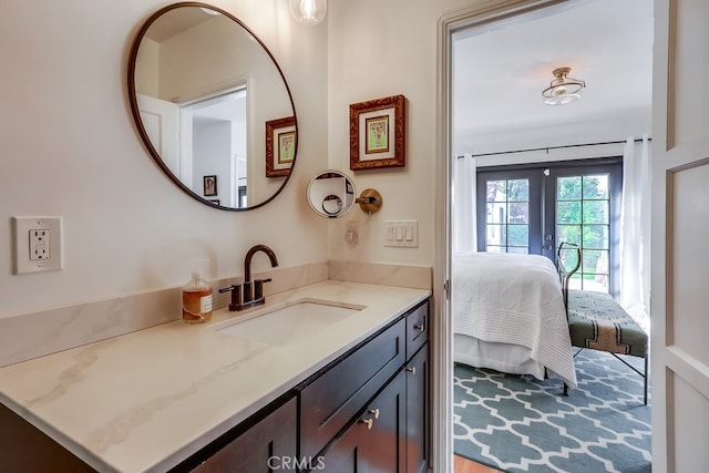 bathroom featuring french doors and vanity