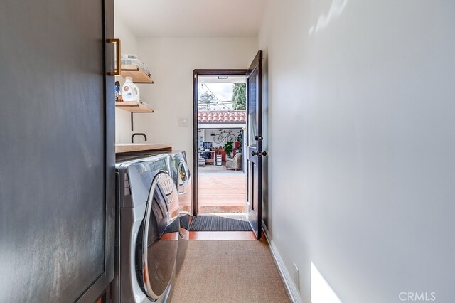 washroom featuring washing machine and clothes dryer and carpet flooring