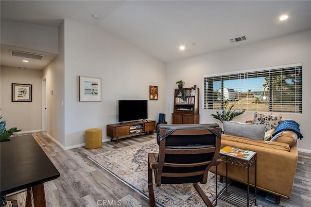 living room featuring hardwood / wood-style flooring and lofted ceiling