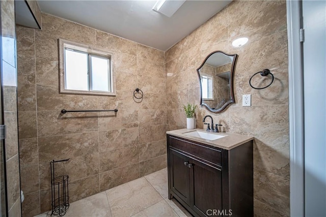 bathroom with vanity and tile walls