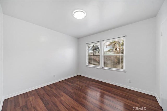 unfurnished room featuring dark hardwood / wood-style flooring