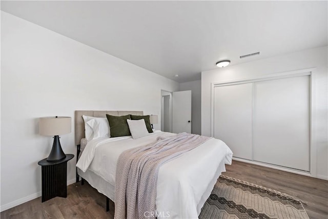 bedroom featuring wood-type flooring and a closet