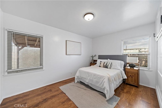 bedroom with dark wood-type flooring