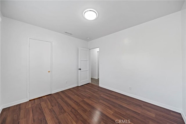 unfurnished bedroom with dark hardwood / wood-style floors