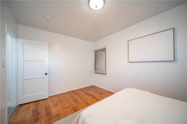 bedroom with wood-type flooring