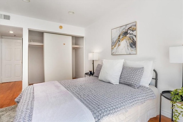 bedroom featuring wood-type flooring and a closet