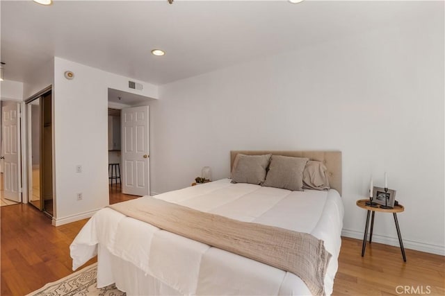 bedroom with hardwood / wood-style flooring